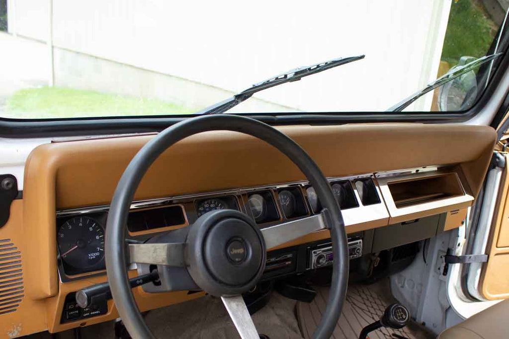 Installed Kentrol T-304 stainless-steel dash overlay for Jeep Wrangler YJ, showcasing the polished stainless-steel..