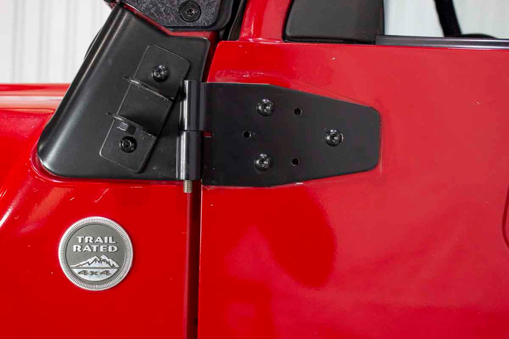 Close-up showing one of four hinges in the Kentrol Door Hinge Set for 2003-2006 Jeep Wrangler 50719 installed to the vehicle's body
