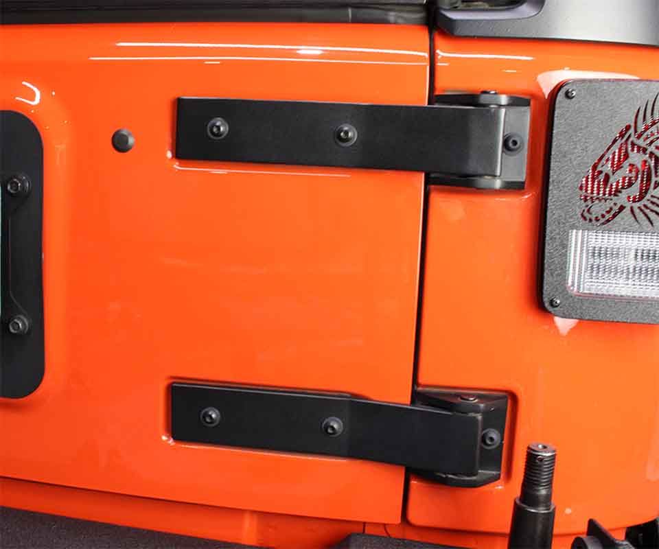 Close-up shot of Kentrol Tailgate Hinge for 2007-2018 Jeep Wrangler 80578 installed to the vehicle's tailgate