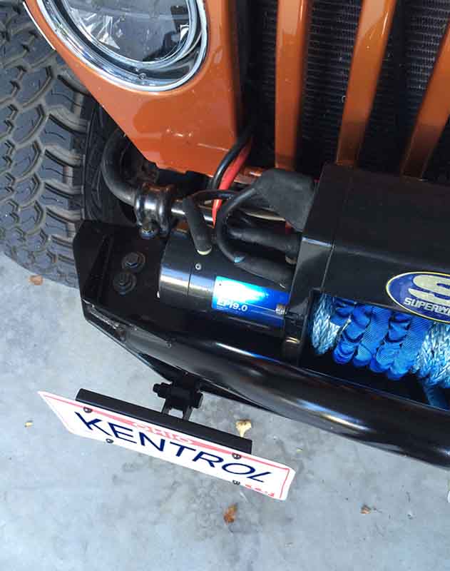 Overhead view of Kentrol Shackle Mounted License Plate Bracket 80706 installed to the vehicle's front bumper