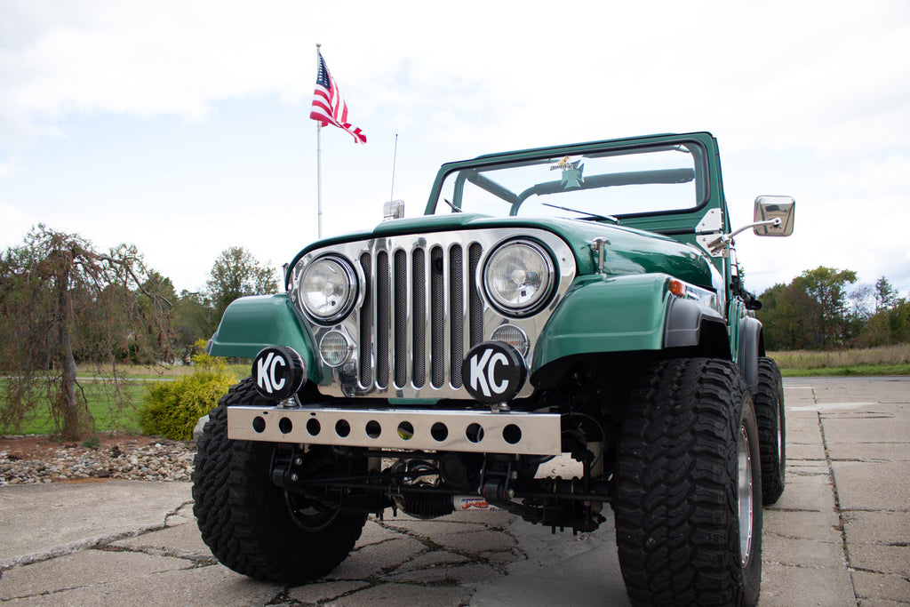 Wide angle, side view of the Kentrol Front Bumper w/holes For 1955-1986 Jeep CJ 30429 installed to the vehicle